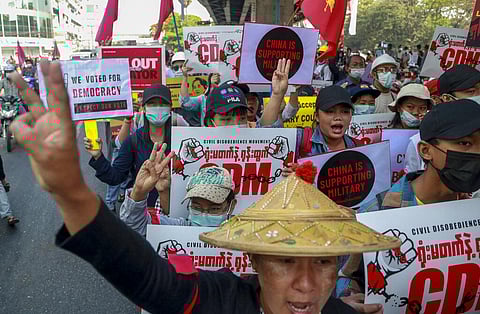 Anti-coup protesters flash the three-fingered salute in Yangon, Myanmar. (Photo | AP)