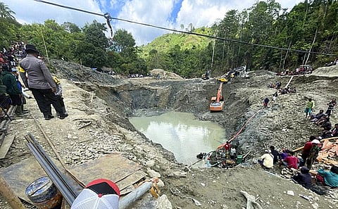 Rescuer workers pump water out of a collapsed gold mine as they search for victims in Parigi Moutong (Photo | AP)