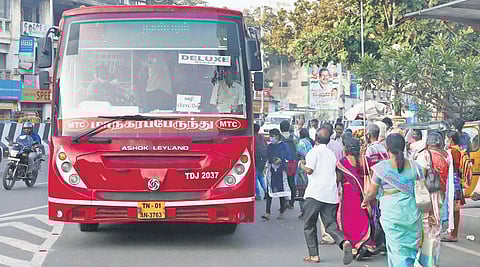 Passengers rush into a bus at the DMS bus stop in Chennai on Thursday | Sri Loganathan V