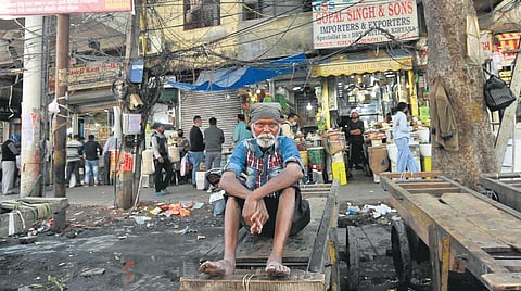 A labourer rests on handcart at Khari Baoli as multiple trade unions called for a nationwide strike on Friday. (Photo | Shekhar Yadav, EPS)