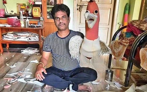 Govindarajulu making puppets at home.