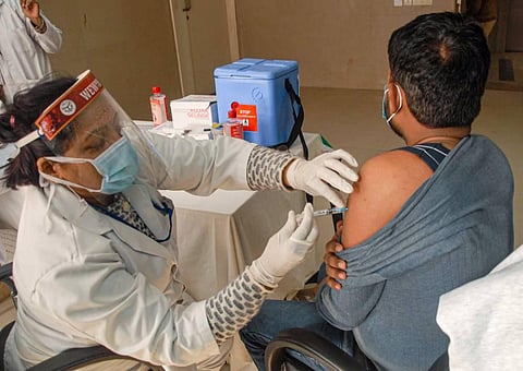 A medic administers the dose of COVID-19 vaccine on a beneficiary. (File Photo | PTI)