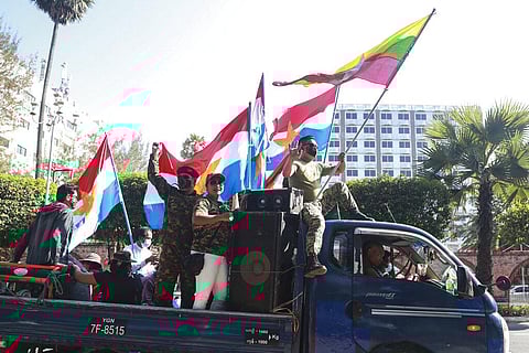 Supporters on a car wave national and military flags Tuesday, Feb. 2, 2021, in Yangon, Myanmar. (Photo | AP)
