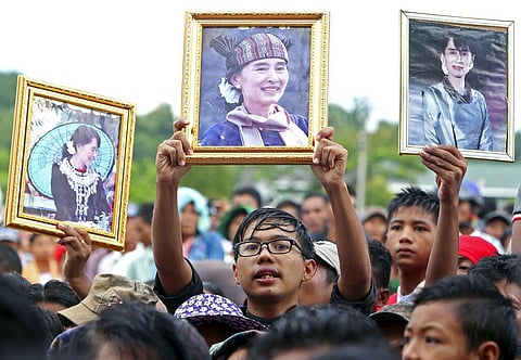 In this Oct. 22, 2017, file photo, supporters raise portraits of Myanmar's leeader Aung San Suu Kyi during a public rally to show their support for her. (Photo | AP)