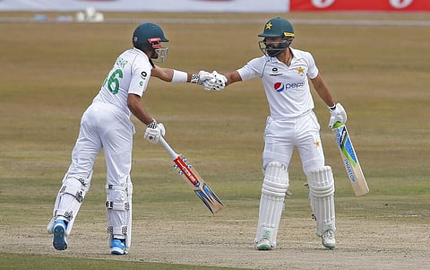 Pakistan's Fawad Alam, right, celebrates with teammate Baber Azam after hitting a boundary in the Test match against SA. (Photo | AP)