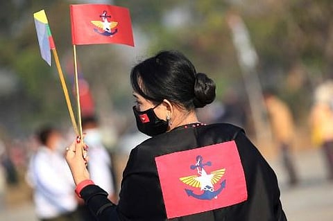 An army supporter carrying the armed forces of Burma flag and the national flag participate in a rally Naypyidaw on February 4, 2021 following a military coup that detained Suu Kyi. (Photo | AFP)