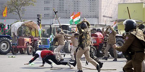 Police personnel start lathi-charge on protesting farmers at ITO during the tractor rally on Republic Day. (File photo| ANI)