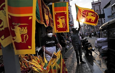Sri Lankan street hawkers sell national flags ahead of the country's 73rd independence anniversary in Colombo. (Photo | AP)