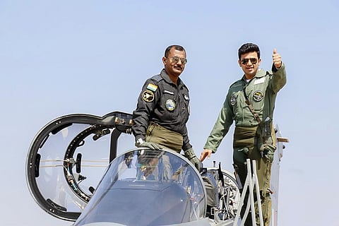 BJP MP Tejasvi Surya gestures as he boards a Light Combat Aircraft Tejas for a sortie during Aero India 2021, in Bengaluru. (Photo | PTI)