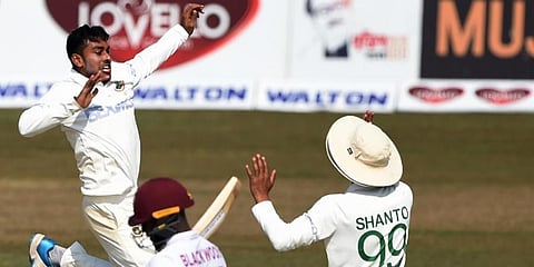 Bangladesh's Mehidy Hasan (L) with his teammates celebrates after the dismissal of West Indies' Jermaine Blackwood during the third day of the first cricket Test match in Chittagong. (Photo | AFP)