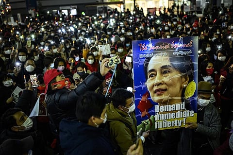 Myanmar activists hold a picture of detained Myanmar civilian leader Aung San Suu Kyi during a protest in Tokyo. (Photo|AFP)