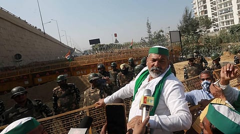 Security personnel stand near barricades as BKU spokesperson Rakesh Tikait gestures during the proposed chakka jam by farmers. (Photo | Shekhar Yadav/EPS)