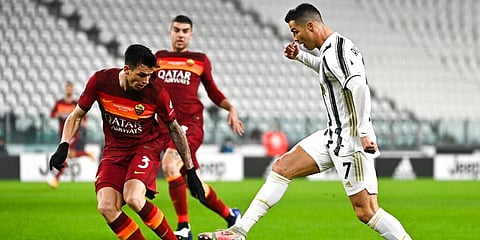 Juventus' Cristiano Ronaldo takes on Roma's Roger Ibanez during a Serie A match. (Photo | AP)