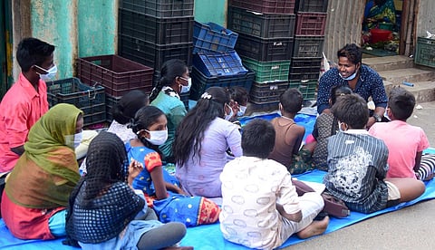 Solomon teaches homeless children at Parry’s Corner in Chennai. He started when classes moved online, as the children don’t have access to mobile phones. (Photo | Martin Louis, EPS)