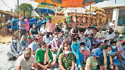 Farmers staging dharna at Bhukta market yard on Monday. (Photo | EPS)