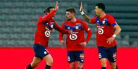 From left, Lille's Yusuf Yazici, Xeka and Jose Fonte celebrate after a goal during their French League One match against Strasbourg. (Photo | AP)