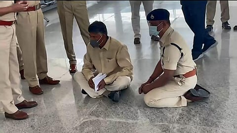 TDP chief Chandrababu Naidu seen squatting at Renigunta Airport as cops prevent him from entering Tirupati on Monday. (Photo | Express)