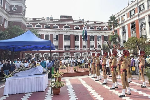 Police officials pay gun salute to Kolkata Police officer Amit Bhawal who lost his life in Eastern Railways Headquarters' fire tragedy. (Photo | PTI)