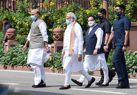 Prime Minister Narendra Modi, Defence Minister Rajnath Singh and BJP National President JP Nadda leave after attending the parliamentary meeting in New Delhi. (Photo | PTI)