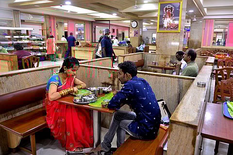 A couple dines at a restaurant in the city. Eateries say they are struggling to keep rates of dishes in check due to rising prices of essential commodities. (File Photo | EPS)