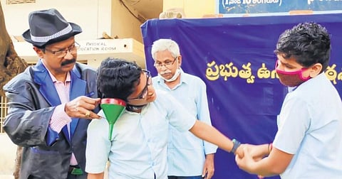 Dr Udatha Sudheer performs a magic show at a school as part of his campaign to promote scientific attitude among students  | express