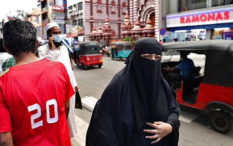 A burqa clad Sri Lankan Muslim woman walks in a street of Colombo, Sri Lanka. (Photo | AP)