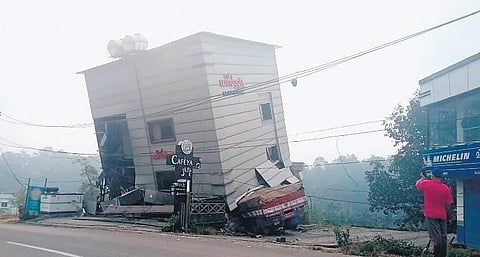 The multi-storey building that was left on the verge of collapse after the lorry rammed it at Vellaramkunnu in Kalpetta on Monday. The building was demolished later | Express