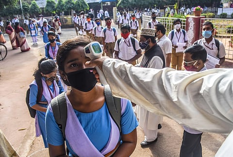 Students being screened for temperature as schools reopen amid rising coronavirus cases. (Photo | Biswanath Swain, EPS)