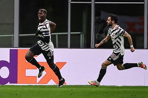 Manchester United midfielder Paul Pogba (L) celebrates Bruno Fernandes after opening the scoring during Europa League match against AC Milan at San Siro stadium on March 18, 2021. (Photo | AFP)