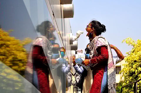 People give their swab samples for Covid-19 test at Sanjeevini bus at ENT hospital in Visakhapatnam on Monday. (Photo | G Satyanarayana, EPS)