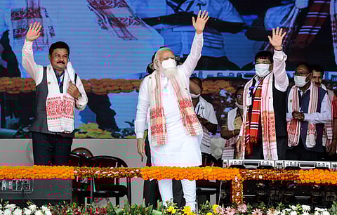 Prime Minister Narendra Modi waves at crowd during his election campaign rally for Assam Assembly polls, at Kamargaon in Golaghat on Sunday. (Photo | PTI)