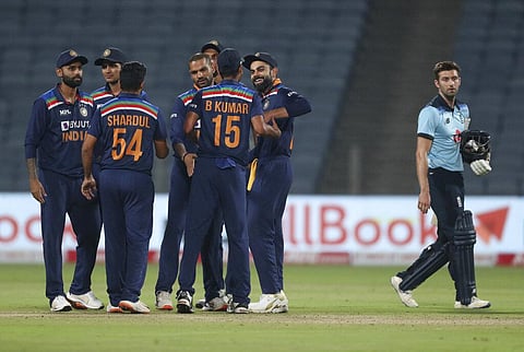 India's captain Virat Kohli and teammates celebrate their win as England's Mark Wood walks off the field at the end of the first ODI. (Photo | AP)