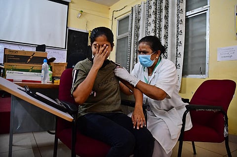 A woman takes a jab at KC General Hospital on Tuesday. The health department staff say they are overworked and cancelling leave only makes it worse. (Photo | Shriram BN, EPS)