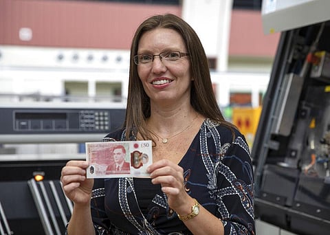 Sarah John, Chief Cashier at the Bank of England, holds the new 50-pound note featuring scientist Alan Turing. (Photo | AP)