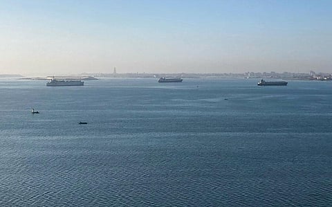 At least 150 vessels are waiting to use the Suez Canal after a skyscraper-sized cargo ship wedged across the vital waterway. (Photo | AP)