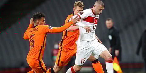 Turkey's Burak Yilmaz (R) is challenged by Netherlands' Owen Wijndal during the World Cup qualifying match. (Photo | AP)