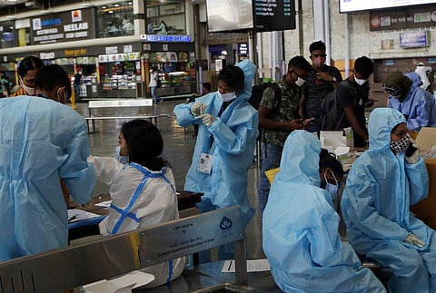 Health workers prepare to takes swab samples to test for COVID-19 at Chhatrapati Shivaji Maharaj Terminus in Mumbai. (Photo | AP)