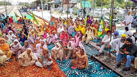 Members of various farmers' organizations block railway tracks during their protest against three farm bills, at Dhablan village in Patiala. (Photo | PTI)