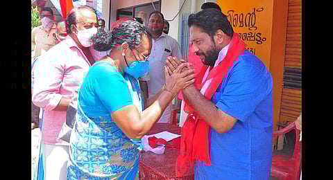 An elderly voter of Varkala constituency greets LDF candidate V Joy at Kaippallikonam during the campaign | Express