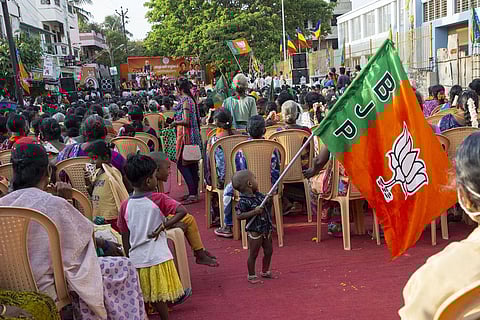 A child holding a BJP flag during the Mahila morcha public meeting in Puducherry. (Photo | G Pattabiraman, EPS)