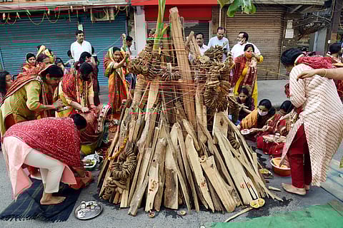 Women perform rituals during 'Holika Dahan' before the Holi festival, in Patna on Sunday. (Photo | ANI)