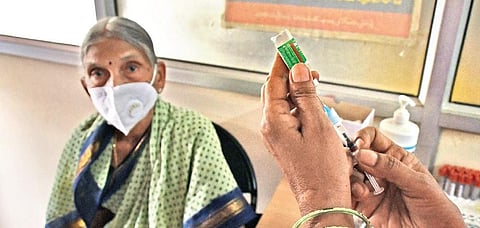 An elderly woman takes Covid vaccination at Giripuram PHC in Vijayawada on Saturday I (Prasant Madugula, EPS)