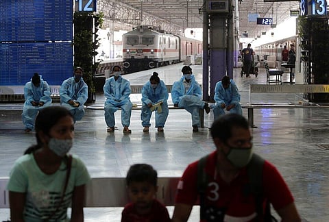 Health workers wait to conduct COVID-19 tests on passengers coming by long distance trains at Chhatrapati Shivaji Maharaj Terminus in Mumbai. (Photo | AP)