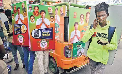 Youth carrying banners of BJP candidate for a pay of `400 during an election campaign at Sowcarpet in Chennai. (Photo | Debadatta Mallick, EPS)