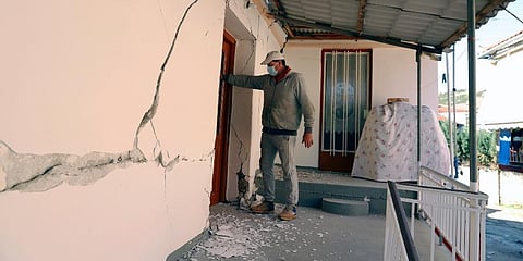 A man checks a house after an earthquake in Mesochori village, central Greece. (Photo | AP)
