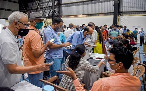 People wait for their turn to receive a dose of COVID-19 vaccine during a countrywide inoculation drive at Nesco Covid centre in Mumbai Monday March 1 2021. (Photo | PTI)