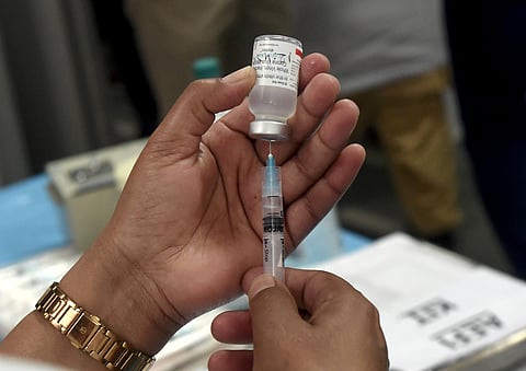 A medic prepares a dose of COVID vaccine in a syringe during a vaccination drive. (File| PTI)
