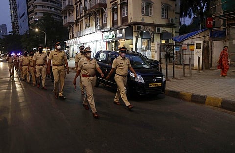 Police officials conduct a flag march during the night curfew imposed by the authorities following the rise in COVID-19 cases in Mumbai. (Photo | AP)