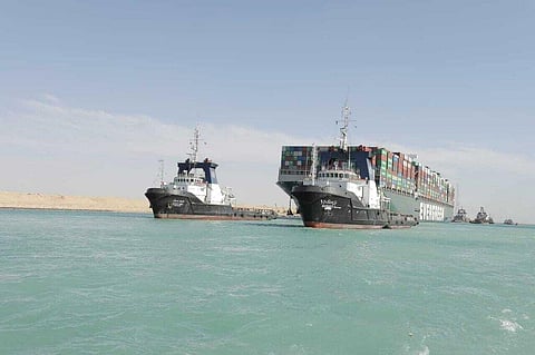 The Ever Given, a Panama-flagged cargo ship is accompanied by Suez Canal tugboats as it moves in the Suez Canal, Egypt. (Photo | AP)
