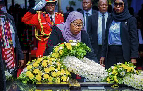 President Samia Suluhu Hassan places flowers on the grave of former President John Magufuli in his home town of Chato, Tanzania Friday, March 26, 2021. (Photo | AP)
